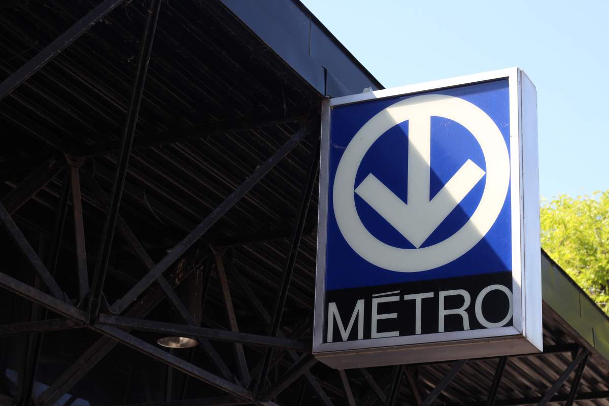 A sign hangs outside a métro station in Montreal, Que.