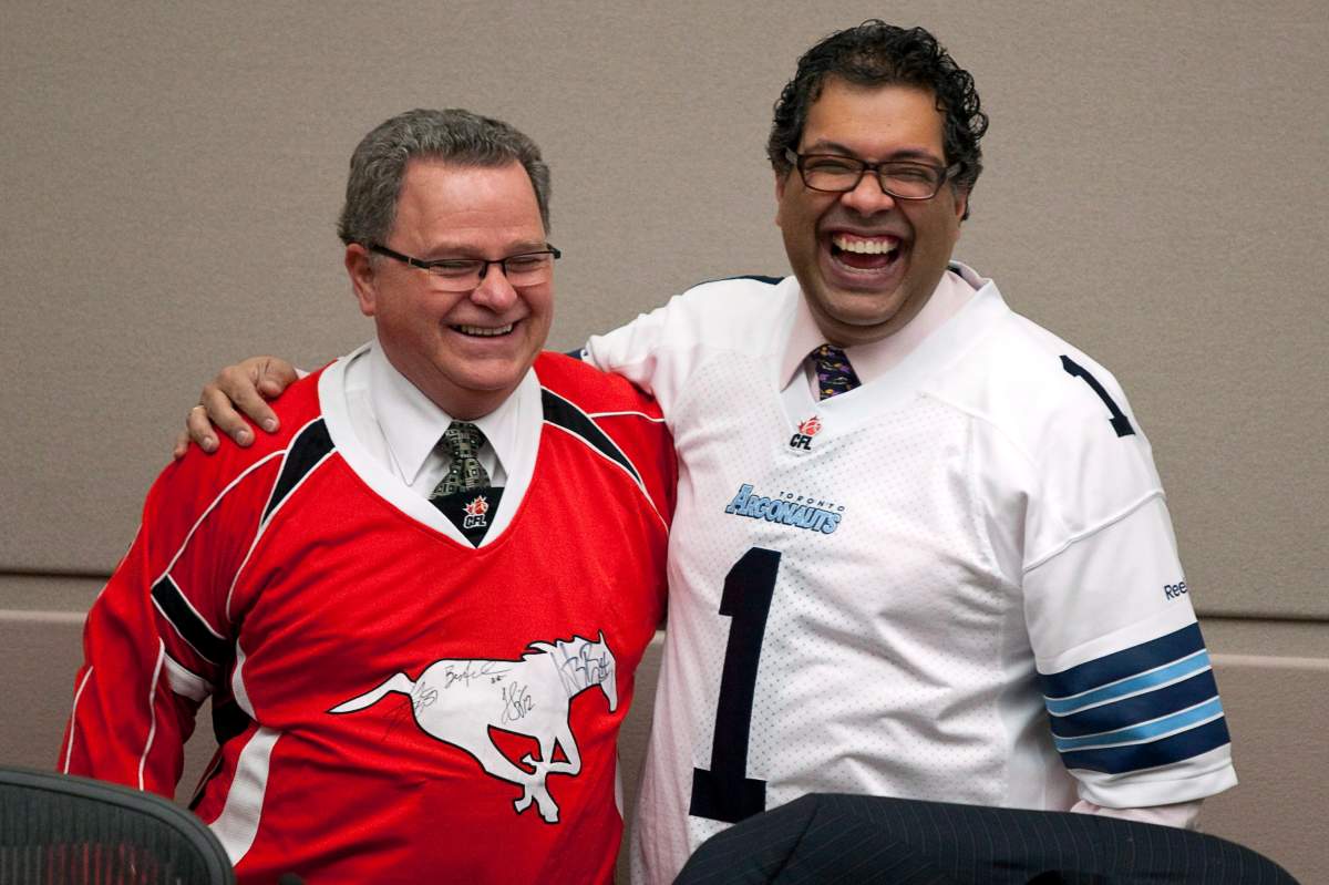 Calgary Mayor Naheed Nenshi, right, wears a Toronto Argonauts jersey as Councillor Shane Keating wears a Calgary Stampeders jersey before a council meeting in Calgary, Alta., Tuesday, Nov. 27, 2012. Keating announced on June 22, 2020 he would not seek re-election in the 2021 municipal election.