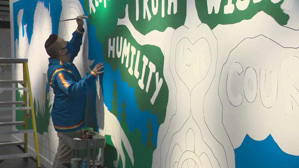 Lance Cardinal works on a 40-foot-long mural inside Edmonton’s IKEA store.