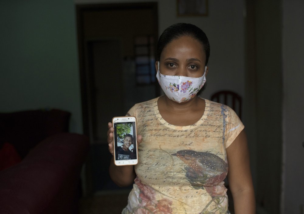 In this Monday, June 15, 2020 photo, Rafaela Matos shows a photo of her son João Pedro Matos Pinto, at her home in Sao Goncalo, Brazil. Matos\’ son was killed on May 18 when police burst into his aunt\’s house and shot the 14-year-old in the stomach with a high-caliber rifle at close range.