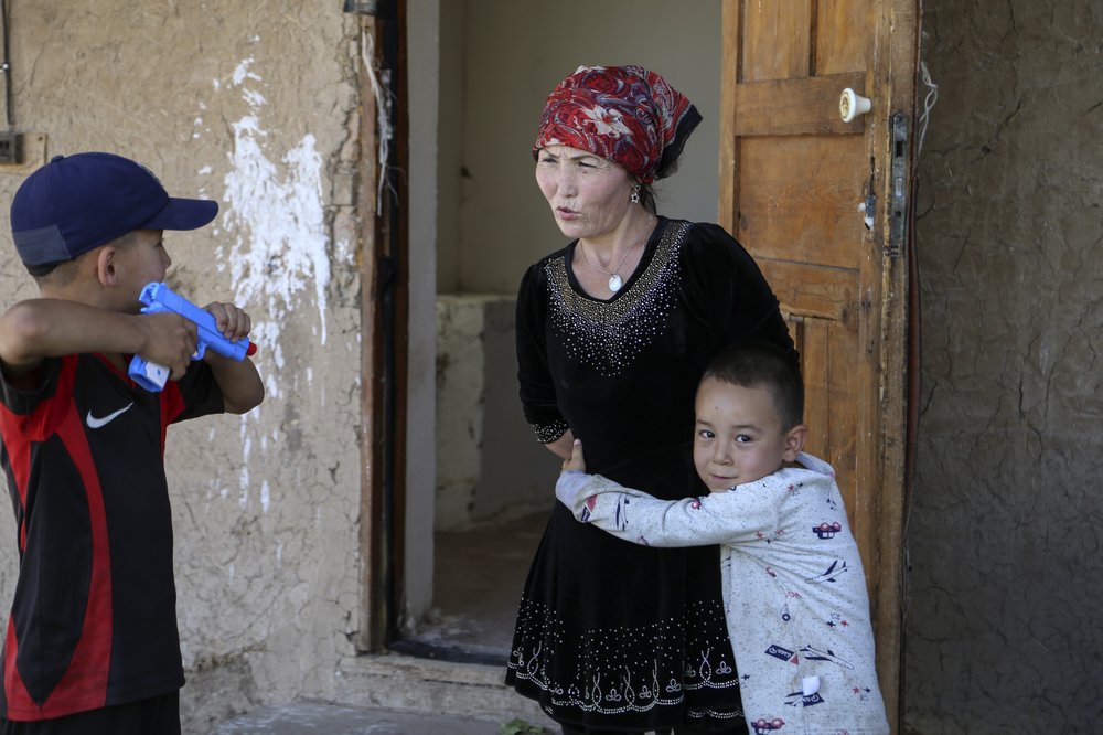 Alif Baqytali hugs his mother, Gulnar Omirzakh, at their new home in Shonzhy, Kazakhstan. Omirzakh, a Chinese-born ethnic Kazakh, says she was forced to get an intrauterine contraceptive device, and that authorities in China threatened to detain her if she didn’t pay a large fine for giving birth to Alif, her third child.