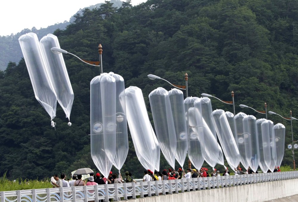FILE - In this July 29, 2010, file photo, South Korean conservative activists launch balloons carrying leaflets denouncing North Korean leader Kim Jong Il during a rally in Hwacheon, South Korea. South Korea says it plans to push new laws to ban activists from flying anti-Pyongyang leaflets over the border after North Korea threatened to end an inter-Korean military agreement reached in 2018 to reduce tensions if Seoul fails to prevent the protests. 
