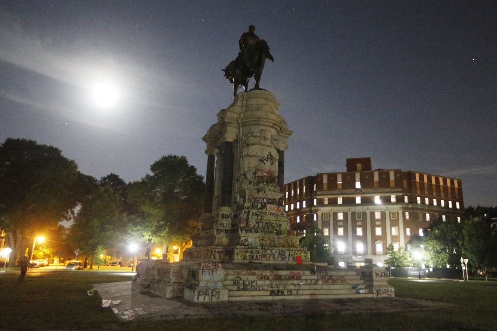 The Moon illuminates the statue of Confederate General Robert E. Lee on Monument Avenue Friday June. 5, 2020, in Richmond, Va. Virginia Gov. Ralph Northam has ordered the removal of the statue. 