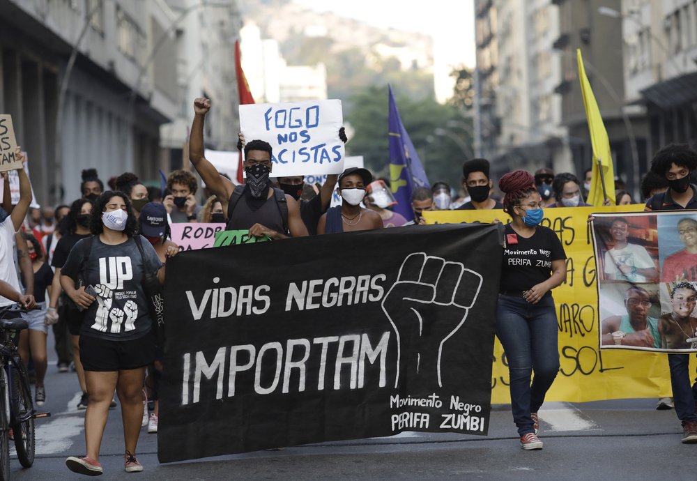 FILE - In this June 11, 2020 file photo, people holding a banner that reads "Black Lives Matter" march during a protest against racism and police violence amid the new coronavirus pandemic in Niteroi, Rio de Janeiro, Brazil. Afro-Brazilian demonstrators outraged by the death of -14-year-old João Pedro Matos Pinto at the hands of police have been organizing the largest anti-police brutality demonstrations in years on the streets of Rio. 