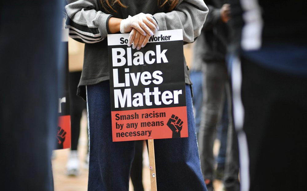 People listen to speeches during a rally to support the Black Lives Matter movement in Birmingham, England, Friday June 19, 2020. A white U.S. Police officer in Minneapolis, recently killed black man George Floyd, sparking anti-racism protests worldwide, and the Black Lives Matter movement hoping to enable reforms and greater social justice. 