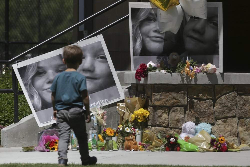 A boy checks out a memorial for Tylee Ryan, 17, and Joshua "JJ" Vallow, 7, at Porter Park in Rexburg, Idaho on Thursday, June 11, 2020.