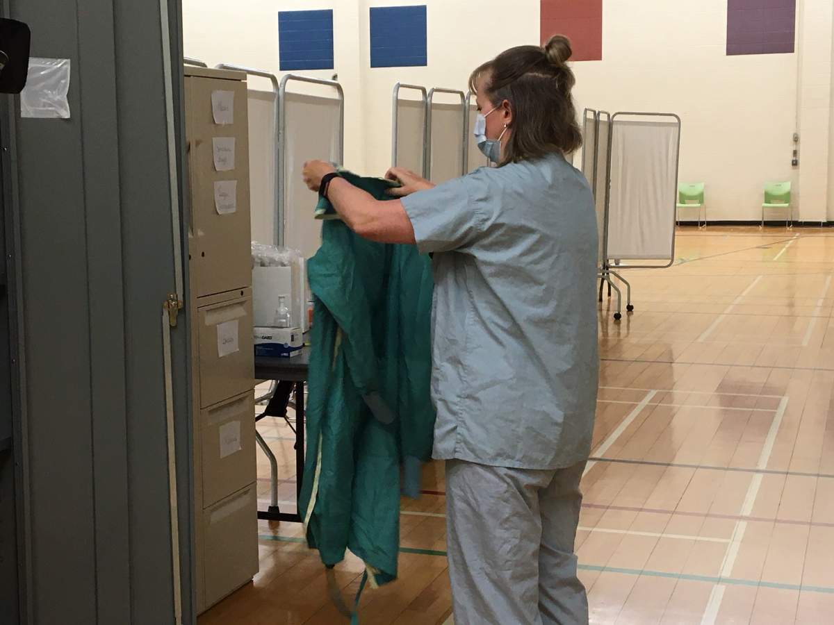 Registered Nurse Jocelyn Tews dons her PPE.