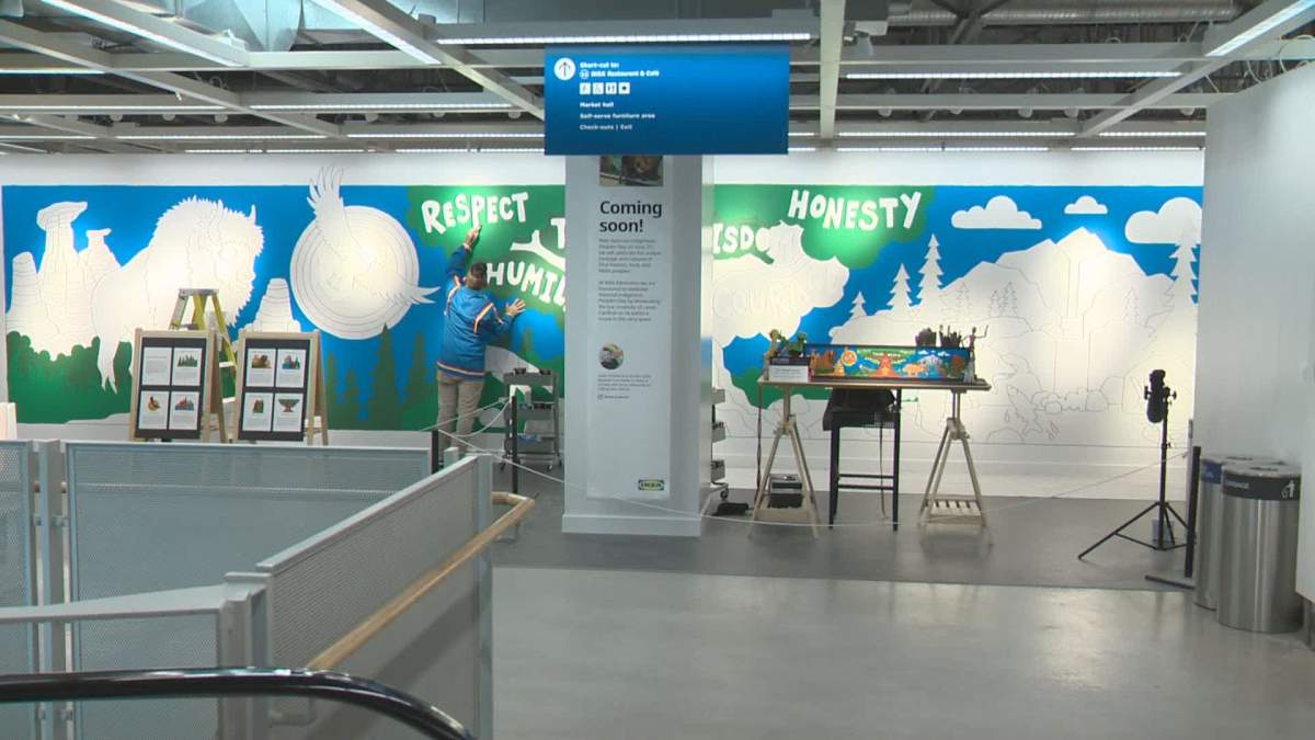 Lance Cardinal works on a 40-foot-long mural inside Edmonton's IKEA store.
