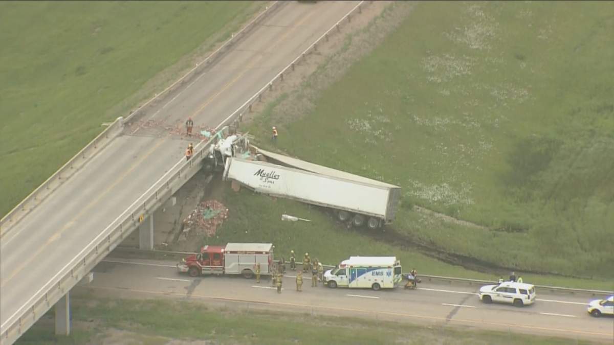RCMP investigate a crash on the QEII at the Highway 616 overpass Wednesday, June 24, 2020.