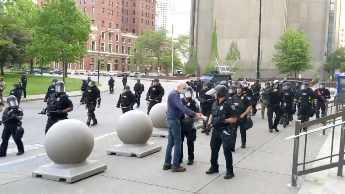 An elderly man approaches riot police during a protest against the death in Minneapolis police custody of George Floyd, in Buffalo, New York, U.S. June 4, 2020 in this still image taken from video. 