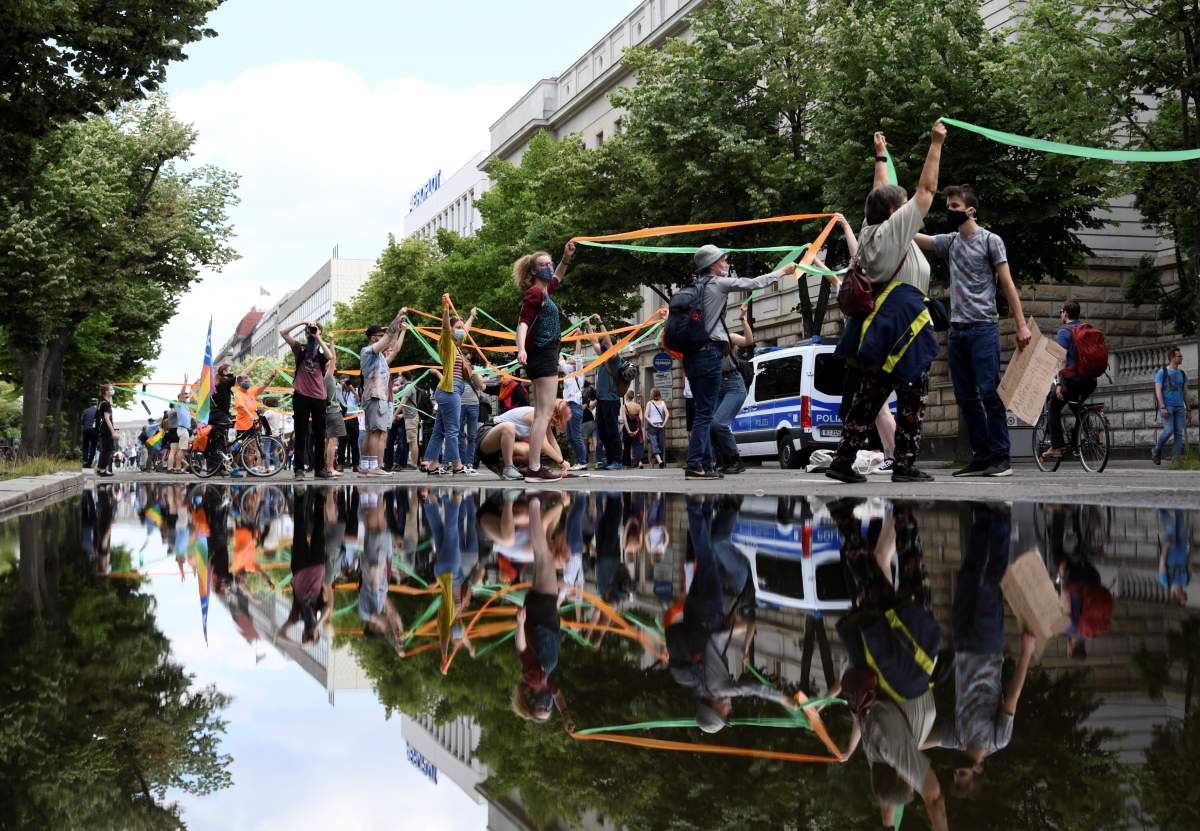 Members of “Fridays for Future” movement, one of the participants of the so-called “Indivisible” demonstration, form a human chain in support of the Black Lives Matter movement and to protest against the lockdown following the coronavirus outbreak, in Berlin, Germany, June 14, 2020.