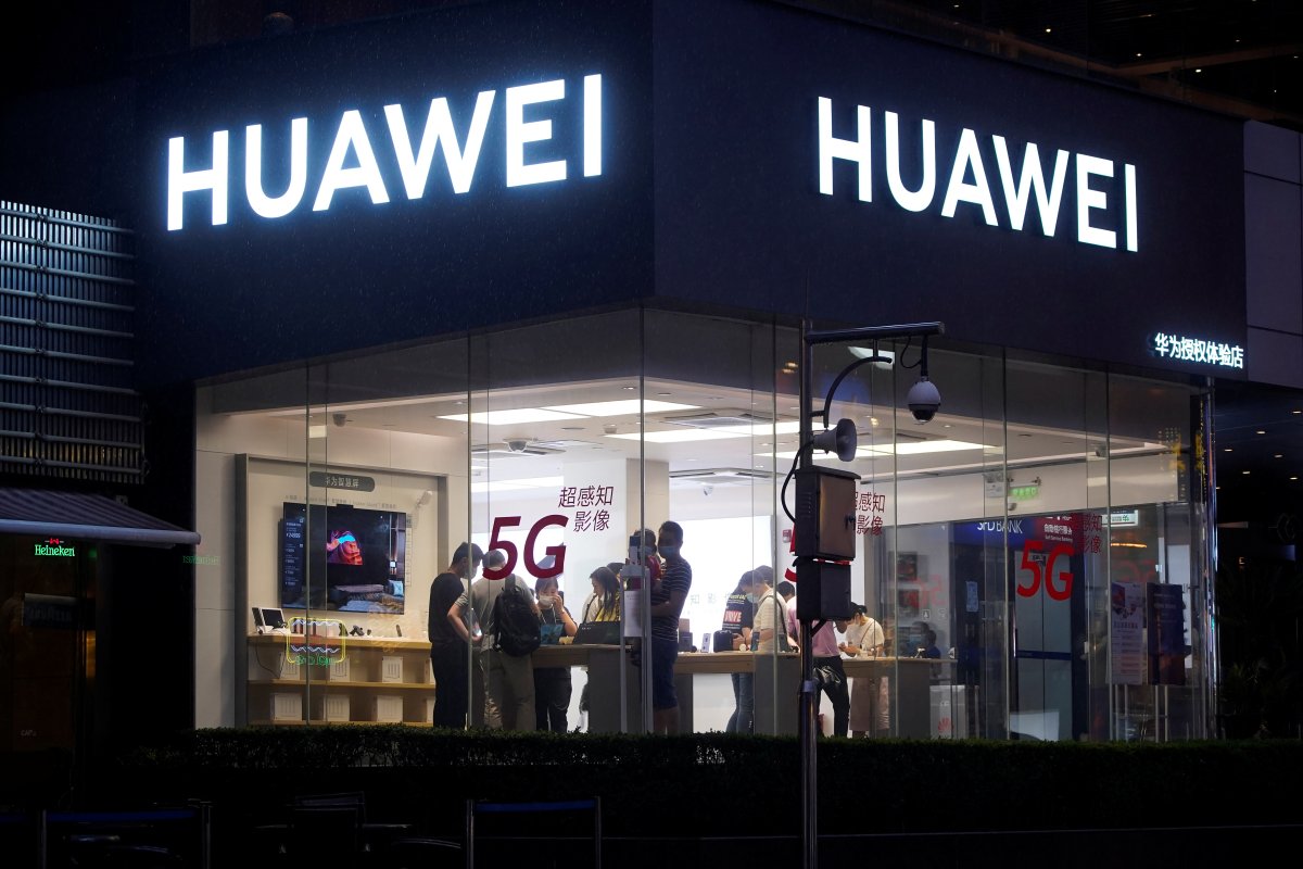 People are seen in a Huawei shop on a street following the coronavirus disease (COVID-19) outbreak, in Shanghai, China June 18, 2020. REUTERS/Aly Song.