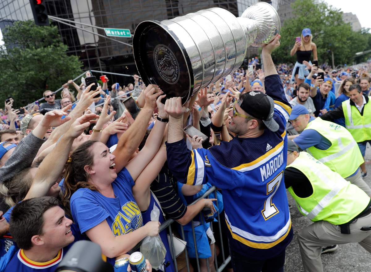 St. Louis Blues left wing Pat Maroon (7) celebrates with fans during the Blues' NHL hockey Stanley Cup victory parade in St. Louis on Saturday, June 15, 2019.