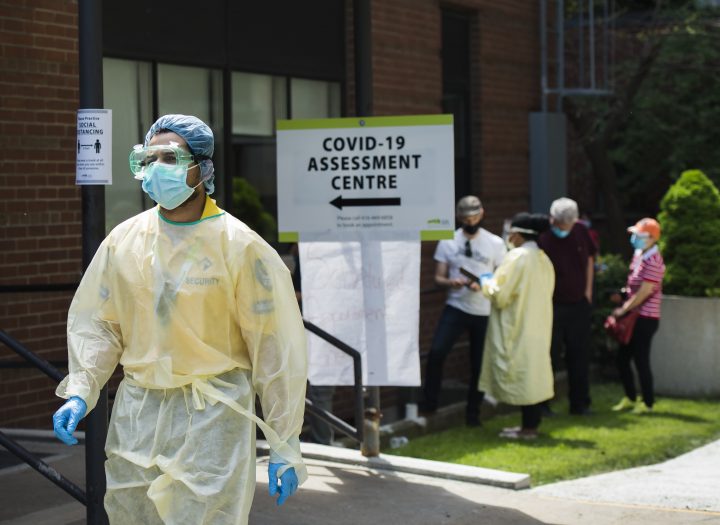 People line up to be tested at a COVID-19 assessment centre in Toronto on Tuesday, May 26, 2020. 