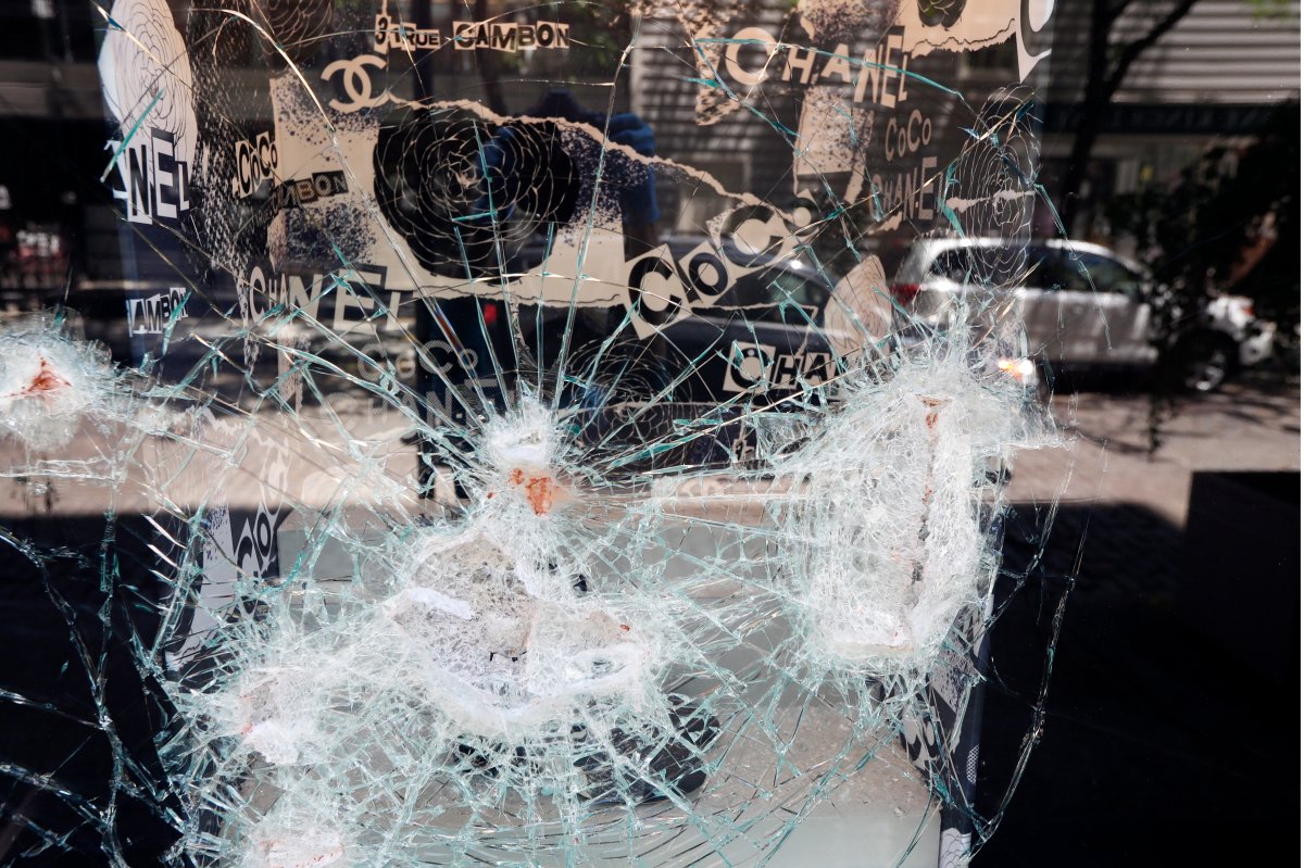 Glass cracked by bricks thrown through the window of a Chanel store by protesters Saturday night is visible, Sunday, May 31, 2020, in New York, at the store in the SoHo neighbourhood of Manhattan.