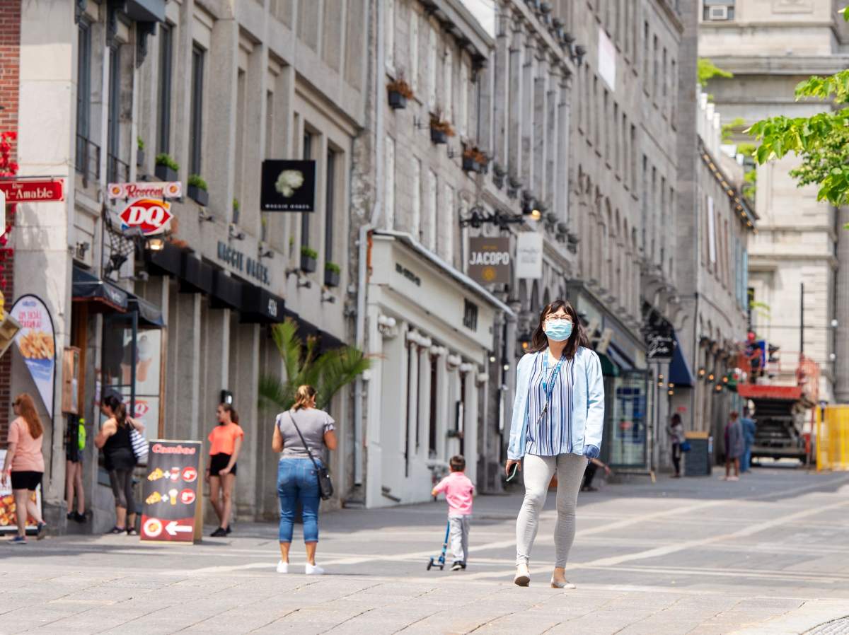 People walk past closed restaurants and bars in Old Montreal Thursday, June 4, 2020 in Montreal. 