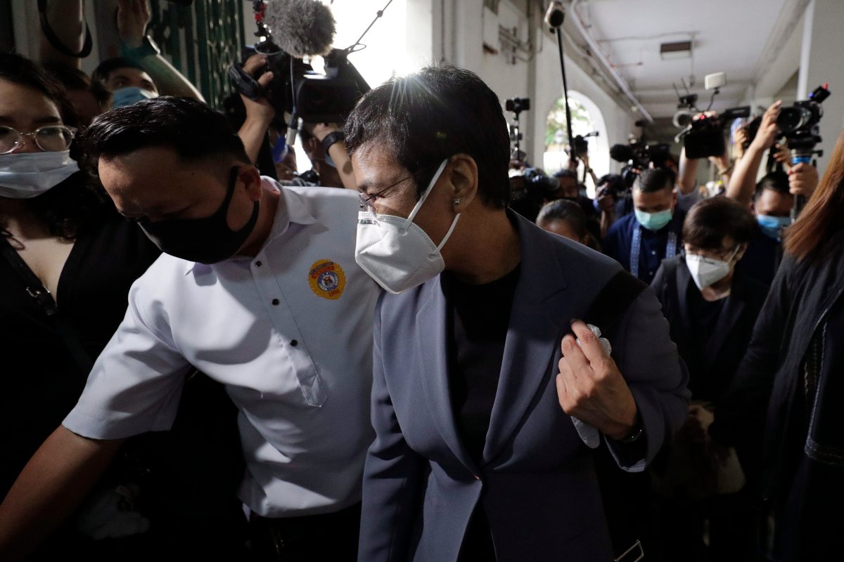 Rappler CEO and Executive Editor Maria Ressa, front right, wearing a protective mask, is escorted as she arrives to attend a court hearing at Manila Regional Trial Court, Philippines on Monday June 15, 2020. 