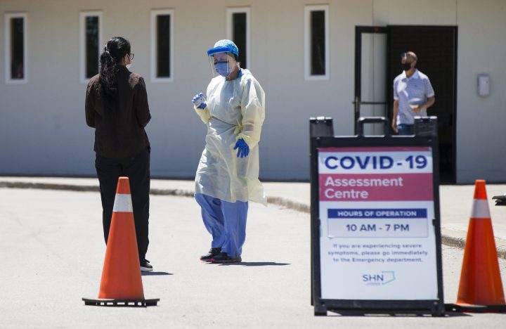 A woman arrives for testing at a COVID-19 assessment centre in Toronto on June 18, 2020. 