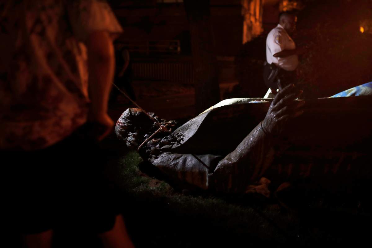 The only statue of a Confederate general, Albert Pike, in the nation’s capital, appears on the ground after it was toppled by protesters and set on fire in Washington on June 20, 2020.