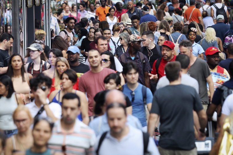 FILE - In this Aug. 22, 2019, file photo, people walk through New York's Times Square. The population of non-Hispanic whites in the U.S. has gotten smaller in the past decade as deaths have surpassed births in this aging demographic, and a majority of the population under age 16 is nonwhite for the first time though they are fewer in number than a decade ago, according to new figures released Thursday, June 25, 2020, by the U.S. Census Bureau. 