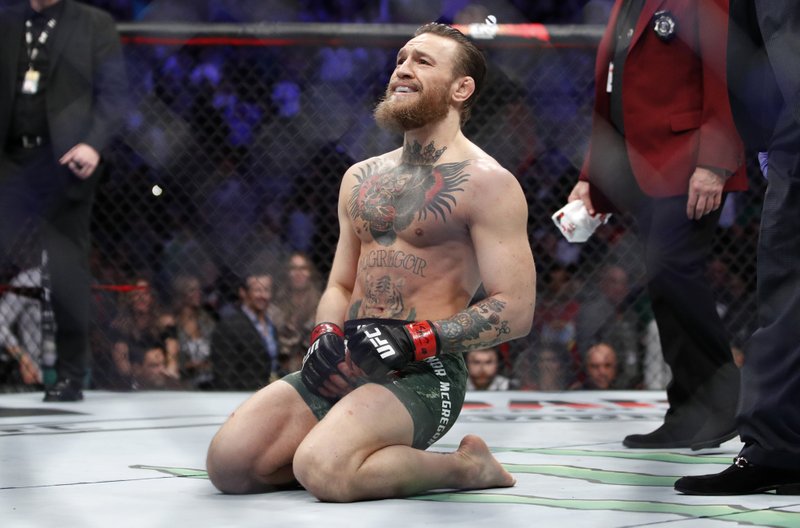 FILE - In this Saturday, Jan. 18, 2020, file photo, Conor McGregor smiles after defeating Donald "Cowboy" Cerrone during a UFC 246 welterweight mixed martial arts bout in Las Vegas. McGregor announced his retirement for the third time in four years, early Sunday, June 7, 2020, on his Twitter account, where the former two-division UFC champion also announced his retirement in 2016 and 2019. 