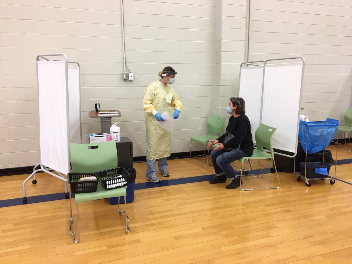 Occupational Therapist Krista Hammond prepares a patient to be swabbed.