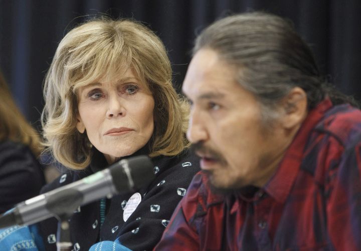 Jane Fonda watches as Athabasca Chipewyan First Nation Chief Allan Adam speaks during a press conference for indigenous rights, in Edmonton, Alta, on Wednesday, January 11, 2017.