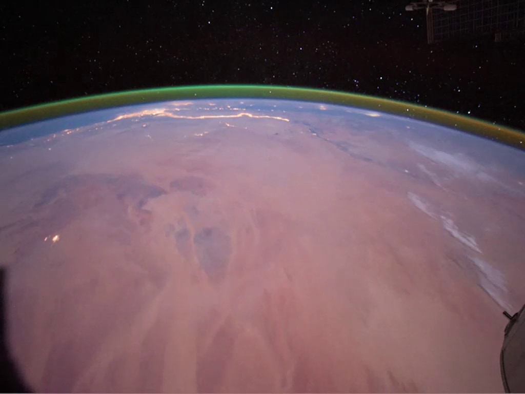 A green ‘airglow’ is shown around the Earth in this image captured on the ISS in 2011.