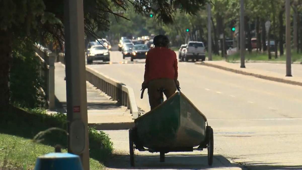 Dr. Darren Markland, portaging his canoe down the street in west Edmonton, Alta., Tuesday June 23.