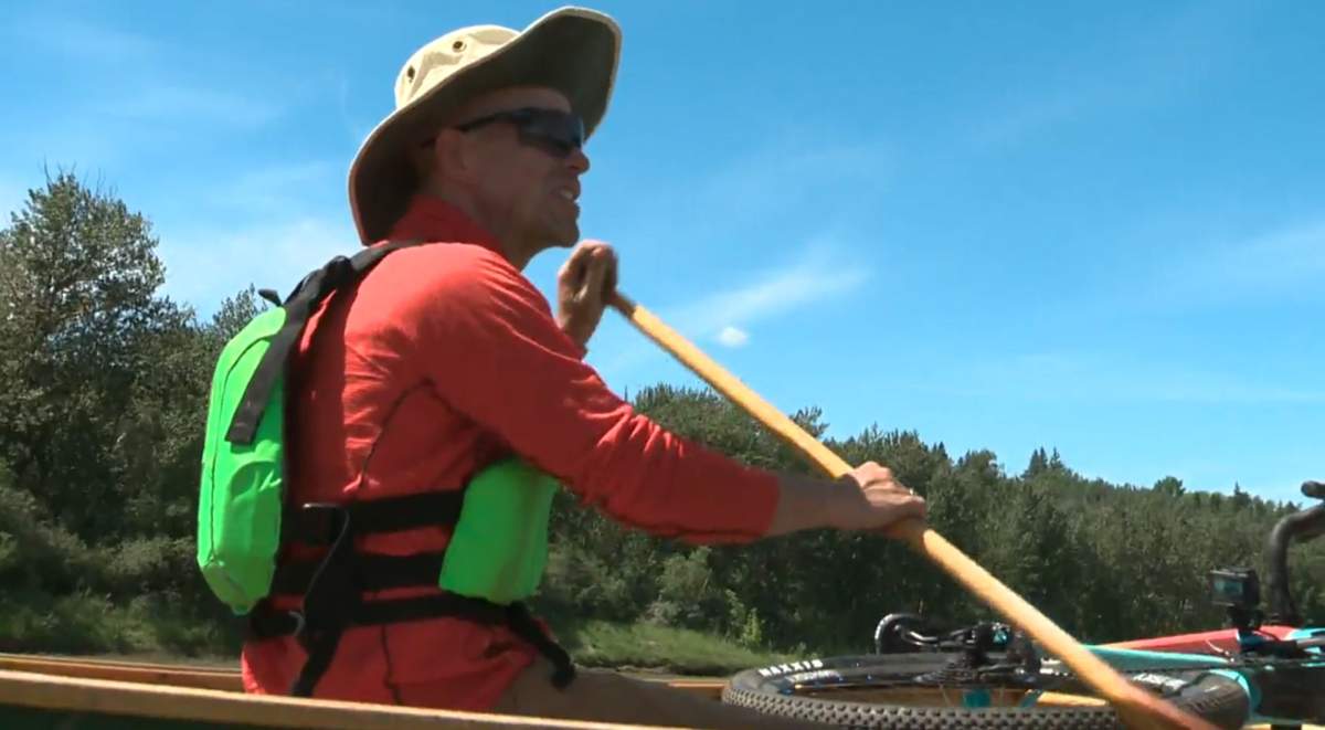 Dr. Darren Markland canoeing down the North Saskatchewan River in Edmonton, Alta., Tuesday June 23.