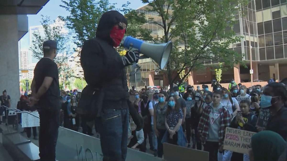 A protester speaks into a megaphone at a Calgary anti-racism rally.