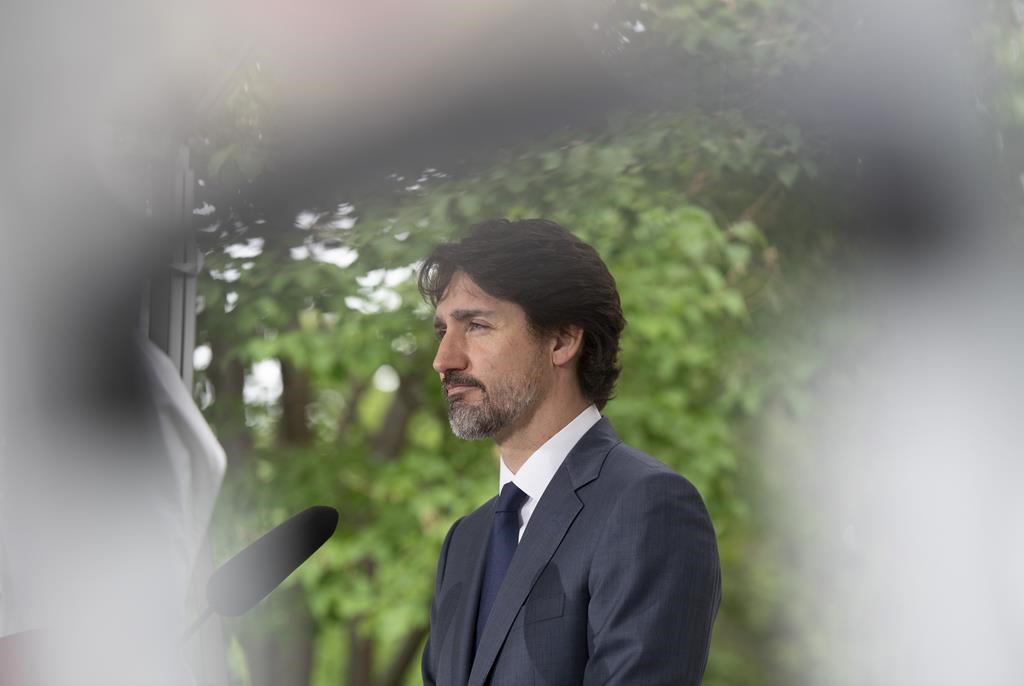 Prime Minister Justin Trudeau responds to a question during a news conference outside Rideau Cottage in Ottawa, Thursday, June 25, 2020, about the same time the Privy Council Office was polling Canadians about the government's response to the coronavirus.