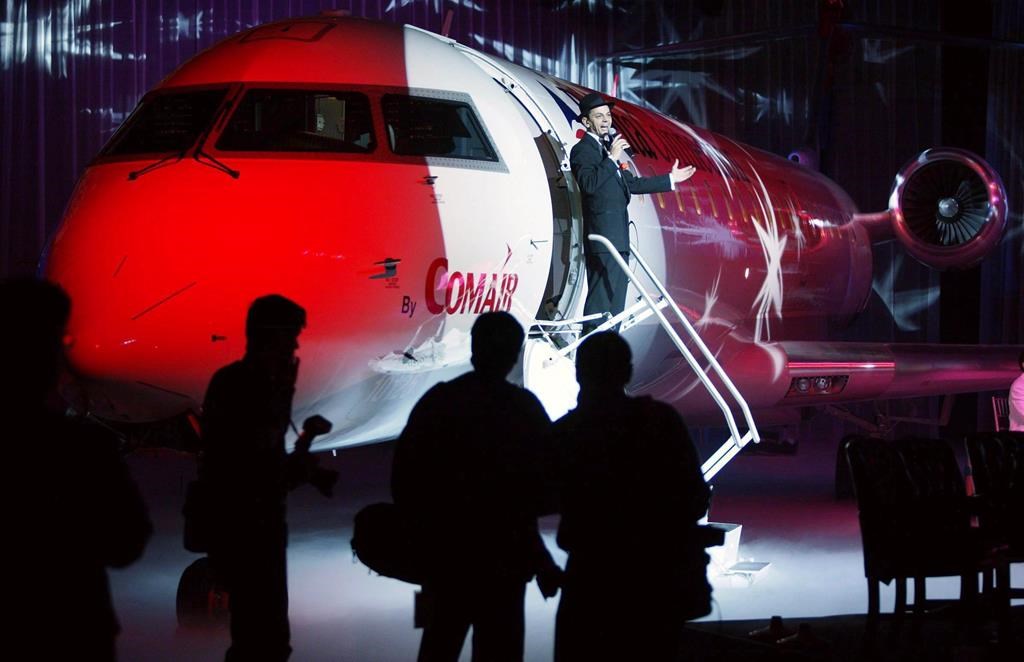 An entertainer sings from the steps of the 1,000th Bombardier Aerospace CRJ regional jet delivered during a ceremony in Montreal, Tuesday, Dec. 9, 2003.