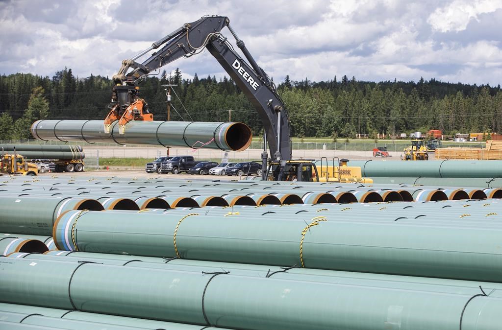 Pipe for the Trans Mountain pipeline is unloaded in Edson, Alta. on Tuesday June 18, 2019.