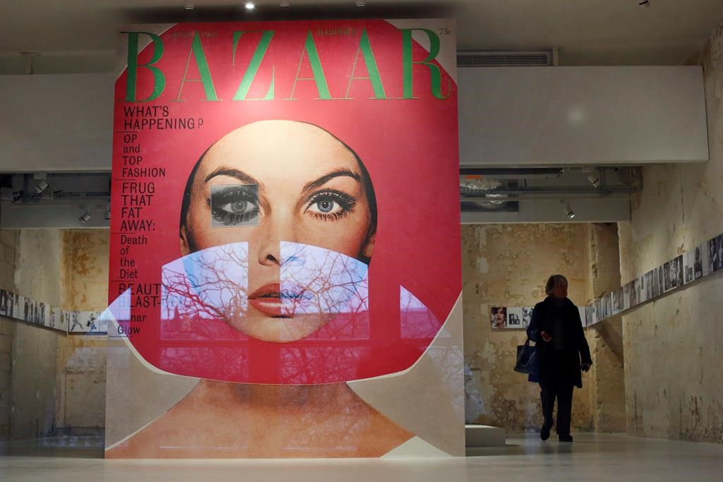 A visitor walks by a giant cover from Harper's Bazar magazine as part of the exhibition Harper's Bazaar, First in Fashion  at the The Musée des Arts Décoratifs, in Paris, Thursday, Feb. 27, 2020. Montreal-born Samira Nasr is the new editor-in-chief of Harper's Bazaar.