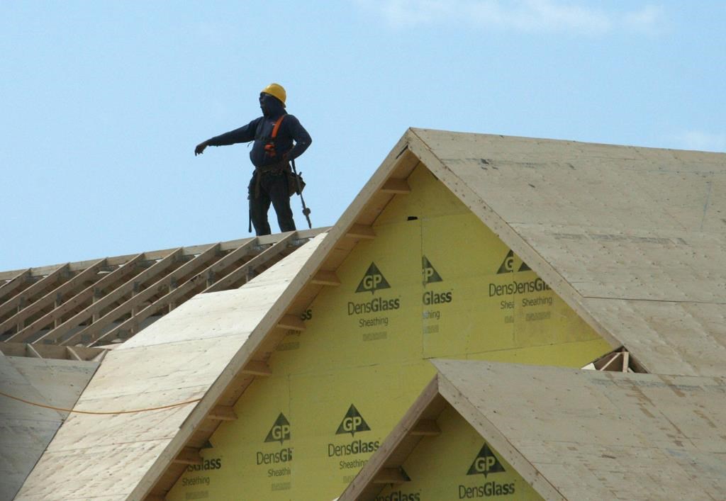 A construction worker works on a new home under construction in Oakville, Ont. on Friday, May 22, 2015.