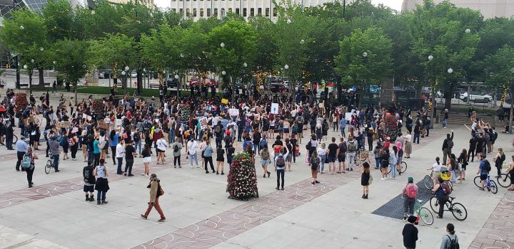 Protesters calling for racial equality and an end to police brutality arrive at Sir Winston Churchill Square in Edmonton on Friday night.
