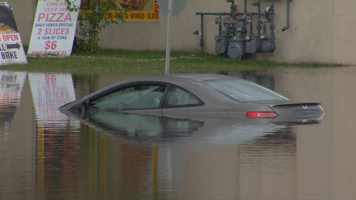 One of many cars submerged in water following a violent storm in Calgary over the weekend