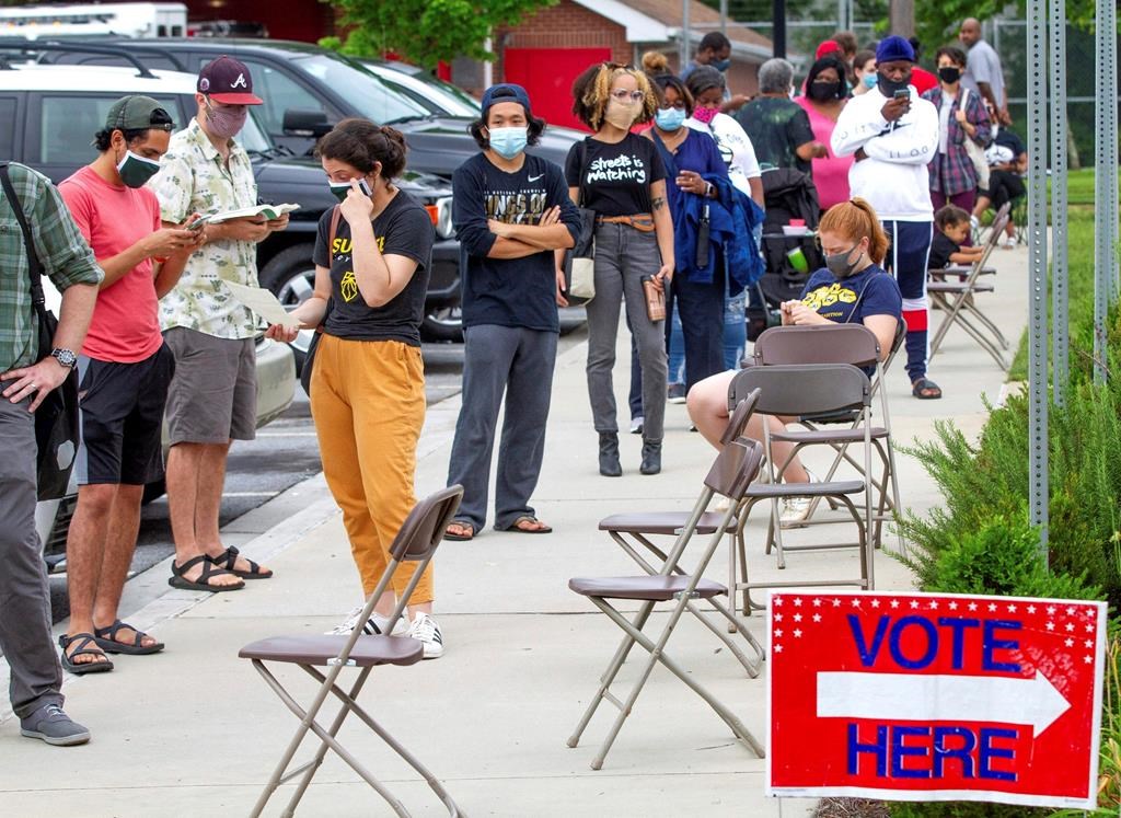 Voters wait in a line that stretched around the Metropolitan Library in Atlanta, Georgia, June 9, 2020.