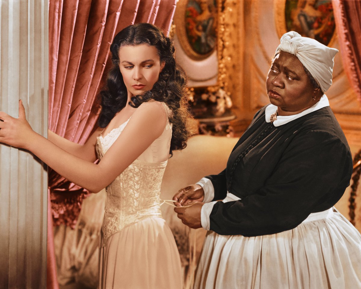 Vivien Leigh has her corset tightened by Hattie McDaniel in a publicity still issued for the film 'Gone with the Wind.'.
