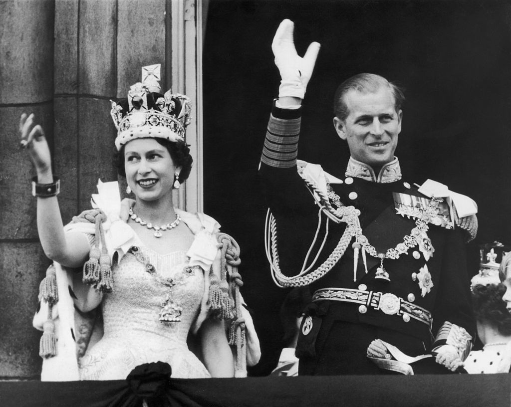 Queen Elizabeth II and the Duke of Edinburgh wave at the crowds from the balcony at Buckingham Palace during Her Majesty’s coronation in 1953.