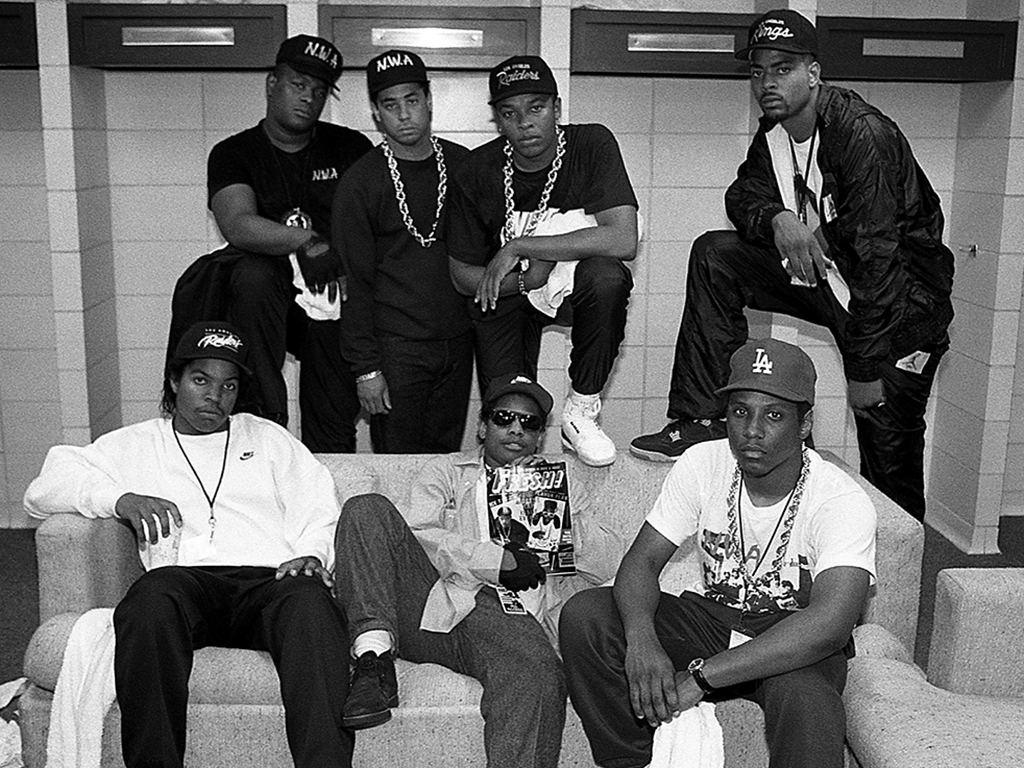 Ice Cube, Eazy-E, MC Ren (front), and rapper Laylaw from Above The Law, DJ Yella, Dr. Dre and rapper The D.O.C. (rear) poses for photos before their performances during N.W.A.'s 'Straight Outta Compton' tour at Kemper Arena in Kansas City, Mo., in June 1989.