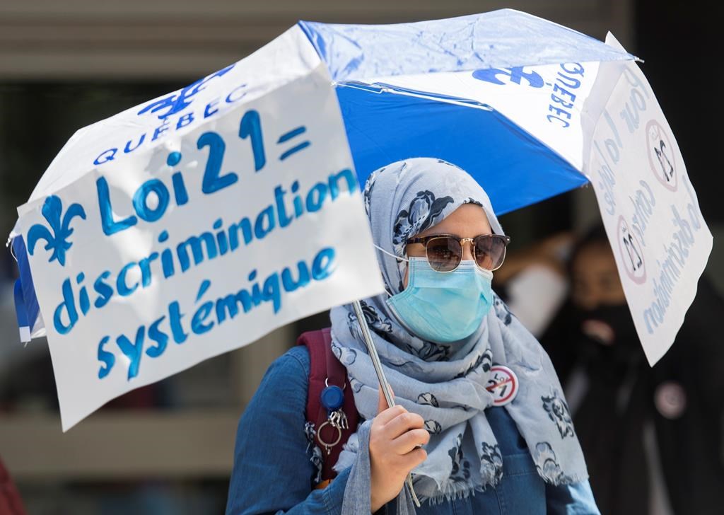 People protest against Law 21 outside Quebec Premier Francois Legault's office in Montreal, Sunday, June 14, 2020, on the one year year anniversary of the controversial bill.
