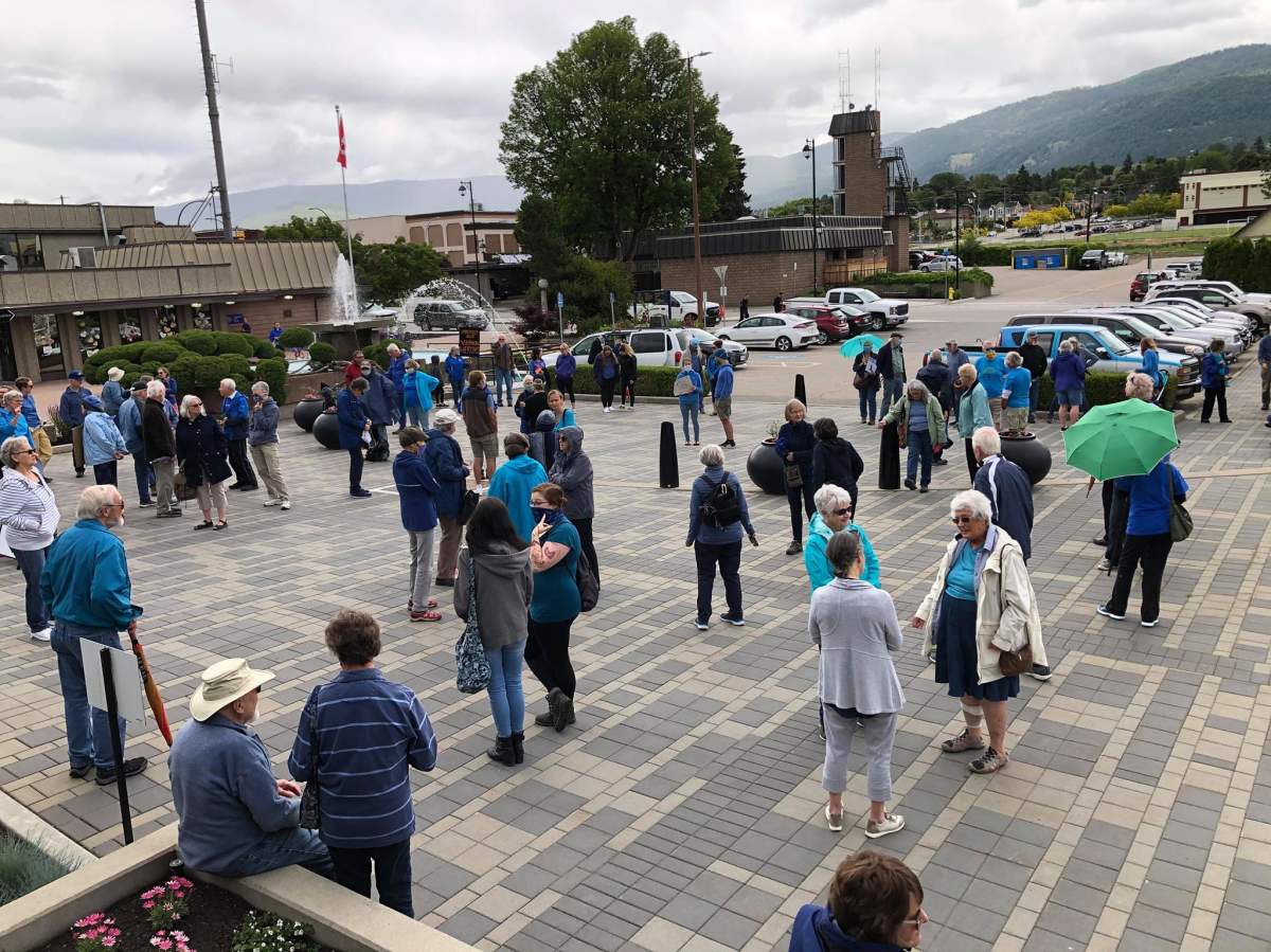 People dress in blue to show their support for the Great Blue Herons outside Vernon city hall Monday.