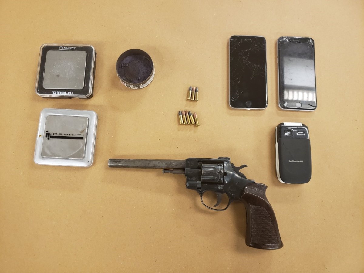 Police say they seized a loaded .22-calibre revolver, eight rounds of .22 calibre ammunition, five grams of fentanyl valued at $1,250, three cellphones and two scales. .