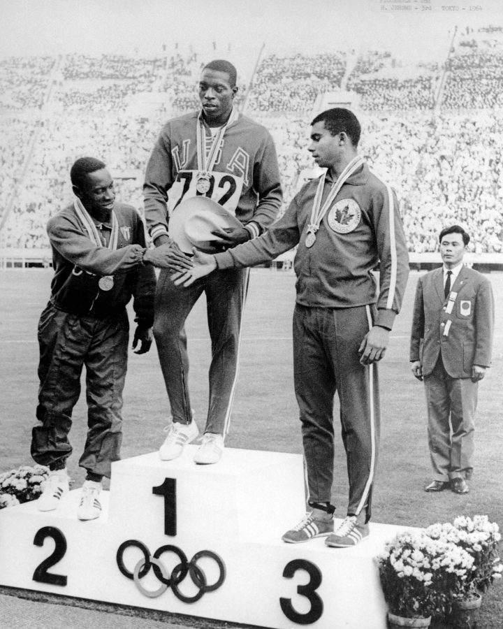 Canada’s Harry Jerome (right) celebrates his bronze medal win in the 100m athletics event at the 1964 Tokyo Olympics.