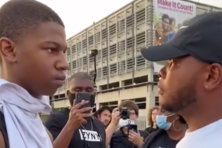 Curtis M. Hayes Jr., right, speaks to a 16-year-old during a protest march in Charlotte, N.C., on May 30, 2020.