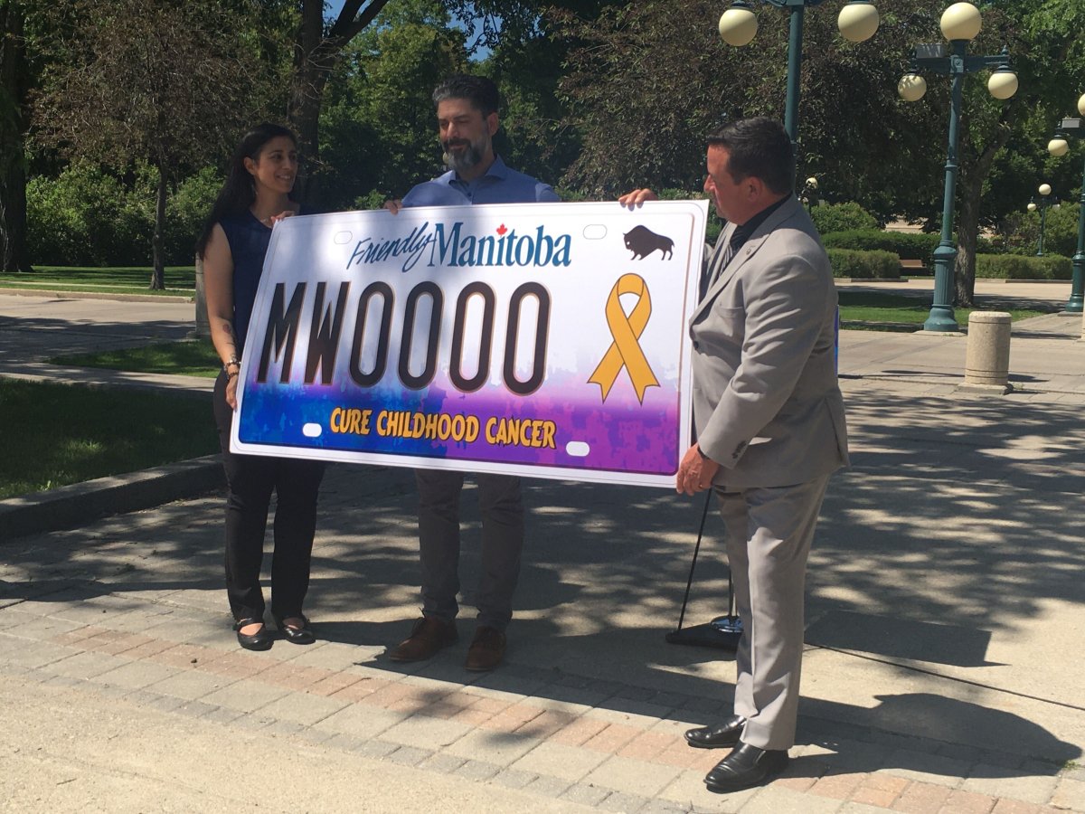 From left, Suzanne and Marco Suzio hold up a new specialty licence plate raising money for Madox’s Warriors Foundation with Crown Services Minister Jeff Wharton.