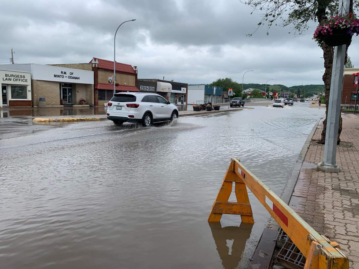 Main Street in Minnedosa was flooded out Monday after heavy rains Sunday. The province is warning another system may bring more rain to southwest, western and central regions of the province over the next two days.