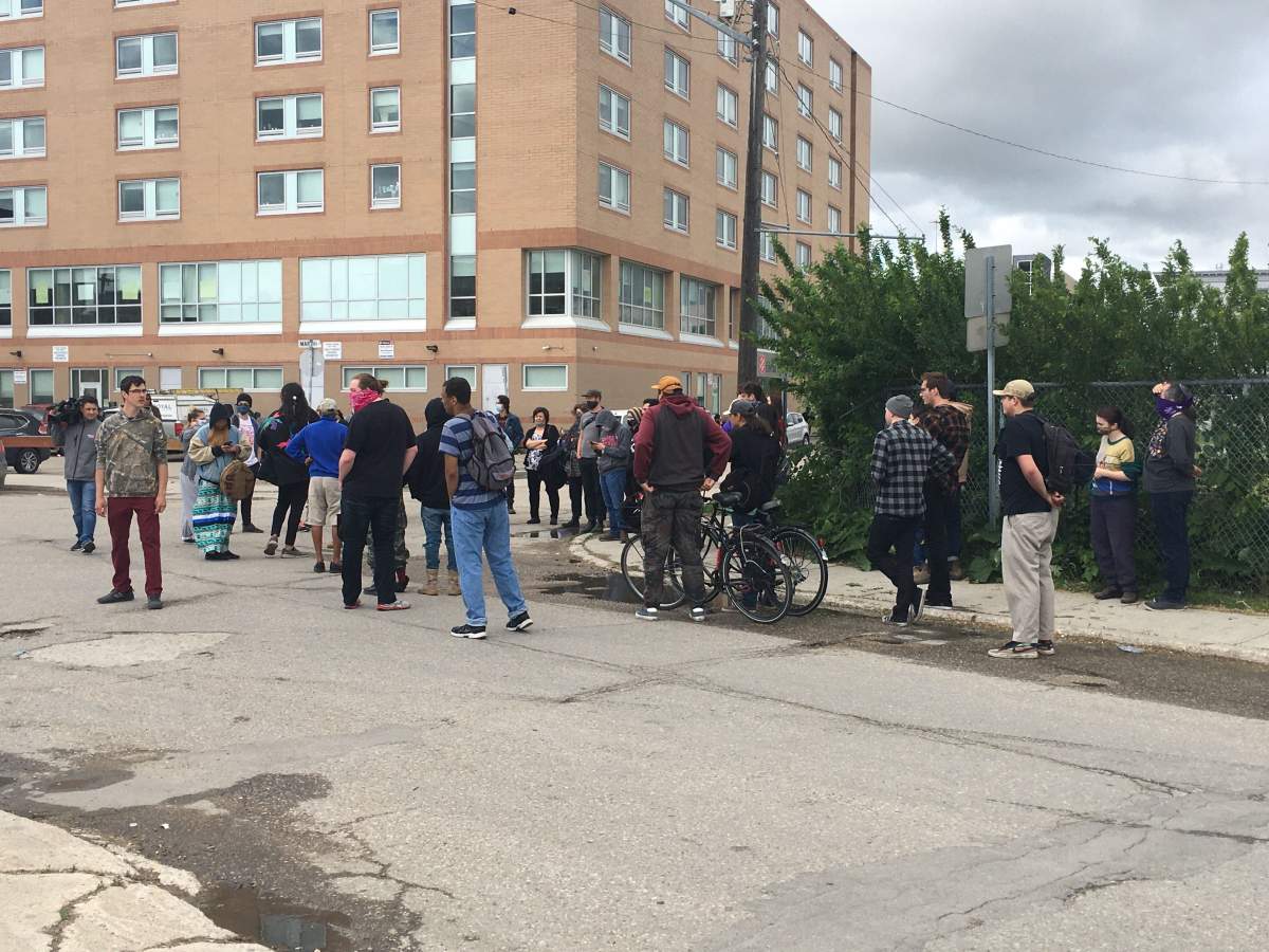 Demonstrators gather to protest the dismantling of the camps Wednesday afternoon.